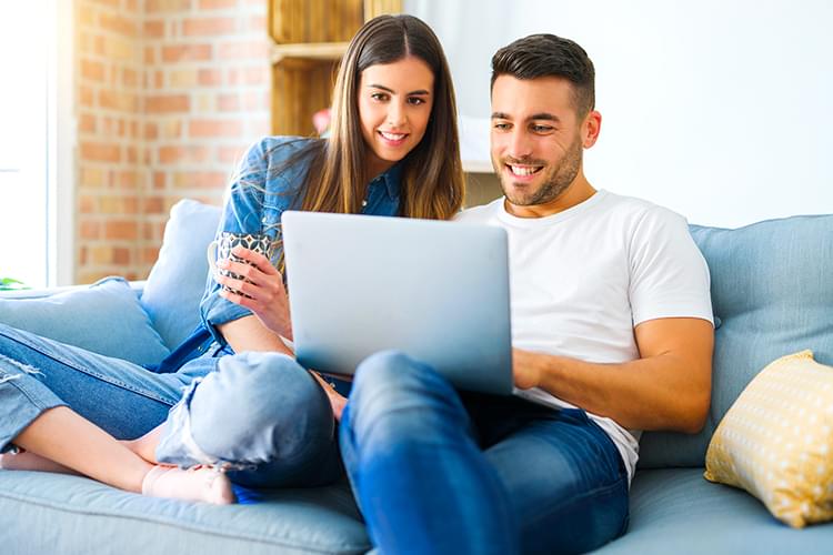 Smiling woman looking at laptop